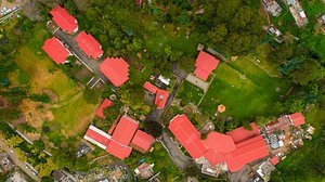 Hotel Kodai International in Kodaikanal, image may contain: Outdoors, Building, Nature, Aerial View