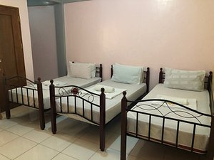 Centillo Travellers Inn in Panay Island, image may contain: Bed, Hostel, Resort, Hotel