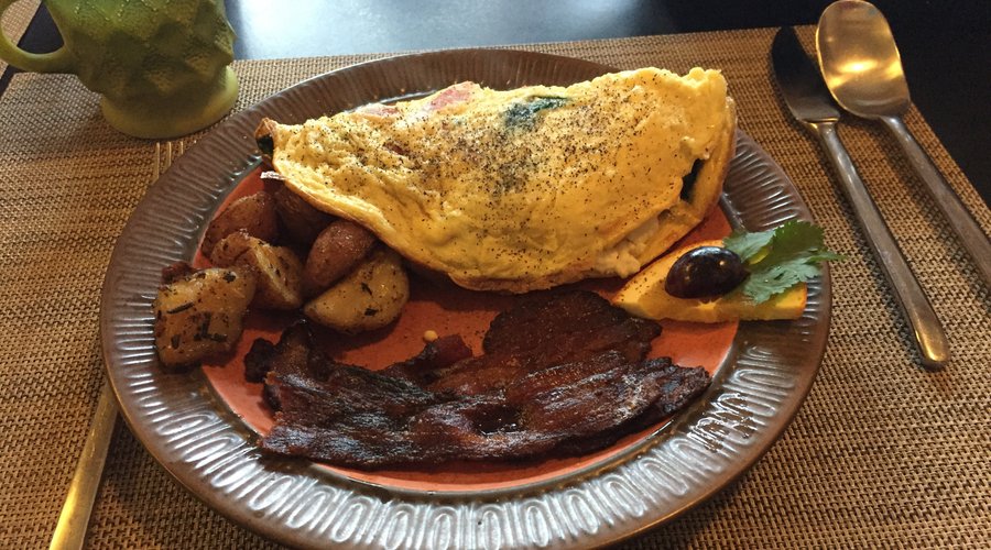 My breakfast selected from the menu.  Mediterranean Omelette with chipotle bacon and a few potatoes.