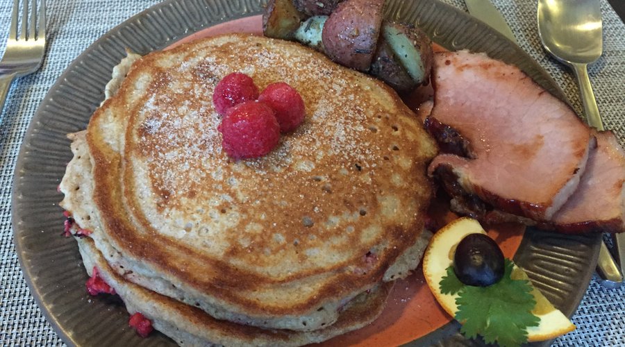 My husband's breakfast.  It was the special of the day.  Raspberry pancakes with ham and he added the potatoes at no charge.