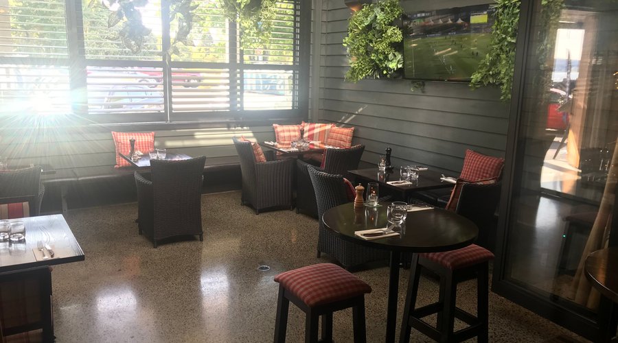 TV side of our bar garden decorated with lots of greenery to help you relax and enjoy the open air (both sides have a roof that opens up to let in the fresh air on sunny days). 