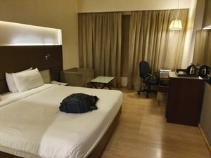 Grand Exotica Business Hotel in Pune, image may contain: Chair, Furniture, Bed, Lamp