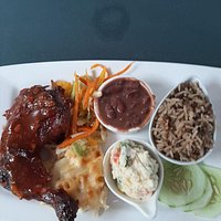 BBQ chicken, macaroni cheese, coleslaw beans, rice and peas with salad and cucumber