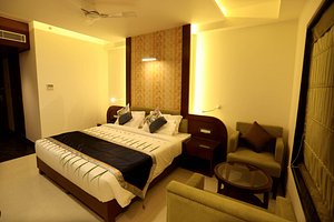 The Pinnacle Inn Sarnath in Varanasi, image may contain: Bed, Furniture, Chair, Bedroom