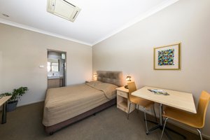 Cessnock Motel in Cessnock, image may contain: Furniture, Corner, Bed, Plant