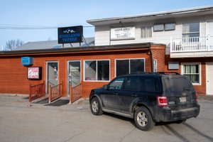 Pamola Motor Lodge in Millinocket, image may contain: Neighborhood, Suv, Car, Hotel