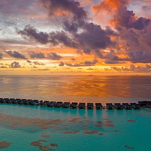 OZEN by Atmosphere at Maadhoo - Water Villa Jetty - Aerial View at Sunset