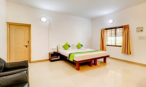 Treebo Trend Pratham Inn Resorts in Tumkur, image may contain: Corner, Furniture, Resort, Interior Design