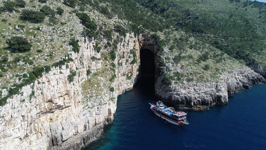Cave of Haxhi Ali  The cave of Haxhi Alia is called Illyrian cave. It has the shape of a cubic of 30m long, maximum height 18m, width 12m and reaches 10m depth. At the end of the cave flow fresh water. It is said that a prominent Ulcinj warrior and seaman named Haxhi Ali fled with his son in this cave. From there they attacked the pirates of the sea and cooperating with the shepherds defended merchants and travelers crossing them. It is located on the Karaburun peninsula near the corner of the t
