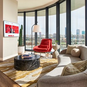 Grand Chamber King Suite living area with Dallas skyline views and wrap around terrace balcony