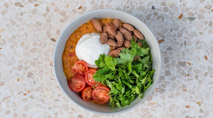 Indian Daal topped with cilantro, skyr, roasted almonds and cherry tomatoes