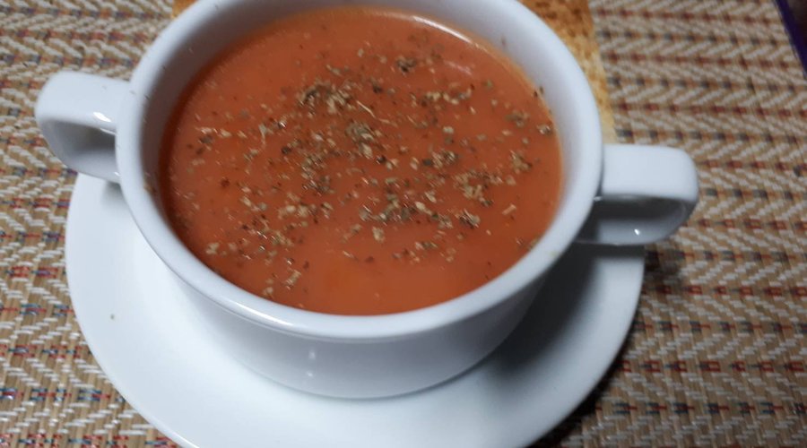 Homemade Tomato Soup with cream and served with wholewheat toasted