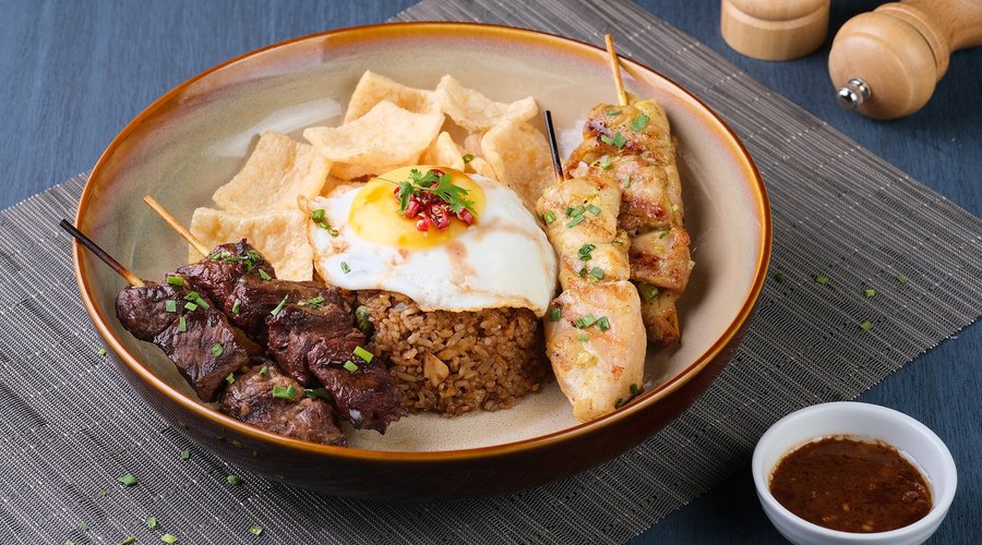 Nasi Goreng or beef and chicken satay cooked Indonesian-style,  is a crowd favorite at Eastwood Cafe+Bar. It is served with scented rice and egg.