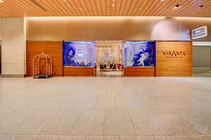 Niranta Airport Transit Hotel & Lounge in Mumbai, image may contain: Floor, Flooring, Indoors, Foyer