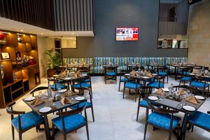 Royal Orchid Golden Suites in Pune, image may contain: Restaurant, Cafeteria, Dining Table, Dining Room