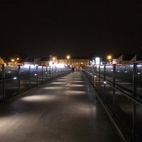 Crossing the bridge from the beach side heading towards the town at night.