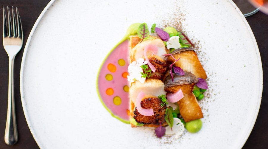 Seared scallops with beurre rouge, oyster mushrooms, fresh peas, house puff pastry.