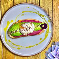 Beetroot hummus, sliced avocado and a poached Katy's farm egg