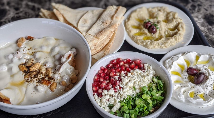 Fetteh bowl, barley salad, labneh, baba ganoush, pita bread