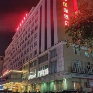 Exterior of the Ocean International Hotel in the Chikan District of Zhanjiang at night.