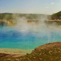 This huge geyser crater with so blue water is near Grand Prismatic Spring. Don't miss this one. You're sure to be bathed in its steam. Hang on to your hat, it's claimed many.