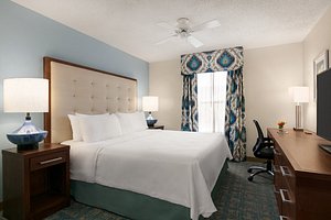 Homewood Suites by Hilton Fort Myers in Fort Myers, image may contain: Table Lamp, Lamp, Bedroom, Furniture