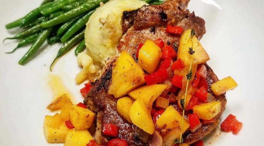 Try our new March Special!
Bone-In Pork Chop topped with peach salsa and served with Garlic mashed potatoes and sauteed green beans.