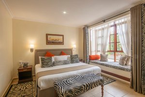 The African Tulip in Arusha, image may contain: Home Decor, Furniture, Bench, Bedroom
