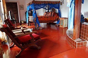 Zanzibar Palace Hotel in Zanzibar Island, image may contain: Furniture, Bedroom, Indoors, Bed