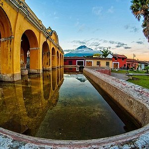 Parque Central (or Plaza Central), the main town square in Antigua Guatemala.,  at night. Famous for its well-preserved Spanish baroque architecture as  well as a number of ruins from earthquakes, Antigua Guatemala