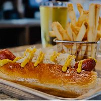 Monster Dogs are served with two massive beef franks on a brioche bun with sauerkraut on the side