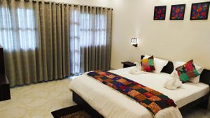 The Cristallo Resort in Shantiniketan, image may contain: Bed, Furniture, Home Decor, Bedroom