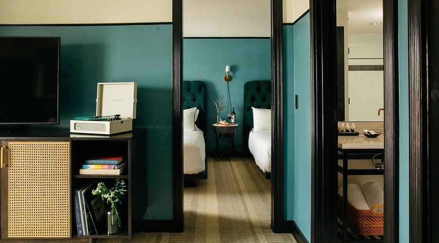 Suite with Two Beds featuring record player and custom vinyl