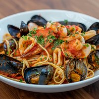 Linguine Adriatica, assorted seafood and shell fish, San Marzano tomato, white wine and garlic.