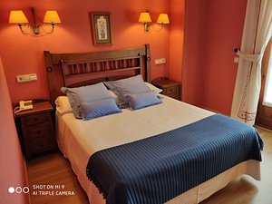 Hotel Nava Real in Navacerrada, image may contain: Bed, Furniture, Bedroom, Indoors