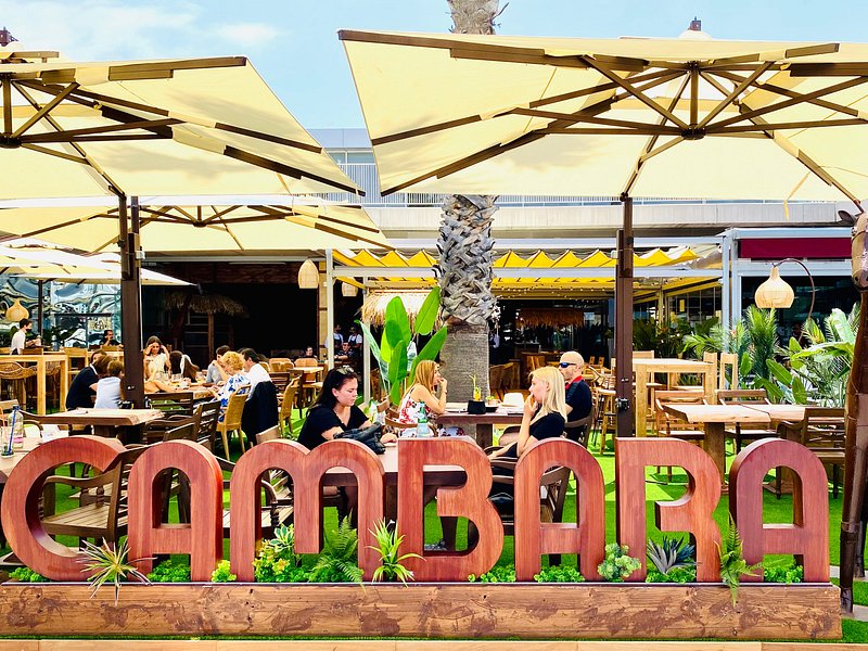 Cambara's modern and chic dining area, with a view of the bustling Muelle Uno