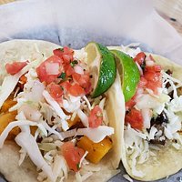 Taco Bus Offerings - Blackened seafood burrito, tamarind soda, marinated pork taco, and butternut squash and portobello mushroom tacos. 🌯🌮