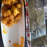 Served cold tater tots with cheese. Dumped into container, sliced cheese just thrown in and of course it did not melt. Took home immediately and heated in microwave and they had a butter chemical taste. Hope we don’t get sick from the one bite we tasted. The shake was good.