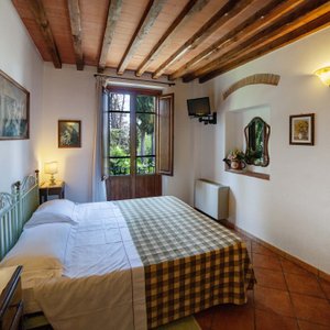 Torciano Hotel Vecchio Asilo in Ulignano, image may contain: Resort, Hotel, Bed, Lamp