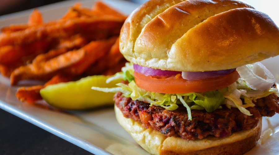 Roasted beet and chickpea veggie burger with sweet potato fries.
