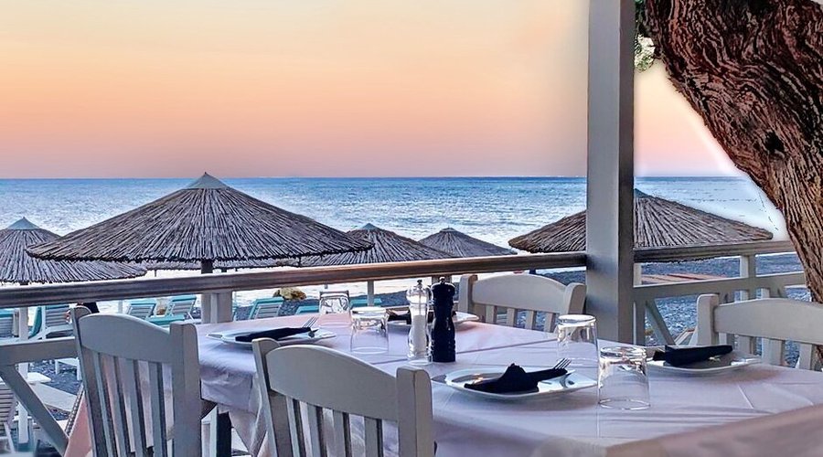 Your Table in our beach-front restaurant in Kamari Beach Santorini - Ariale Restaurant. You can enjoy a special dining experience or a great selection of Wines, drinks and snacks just a few steps away from the famous KAMARI BEACH in Santorini island