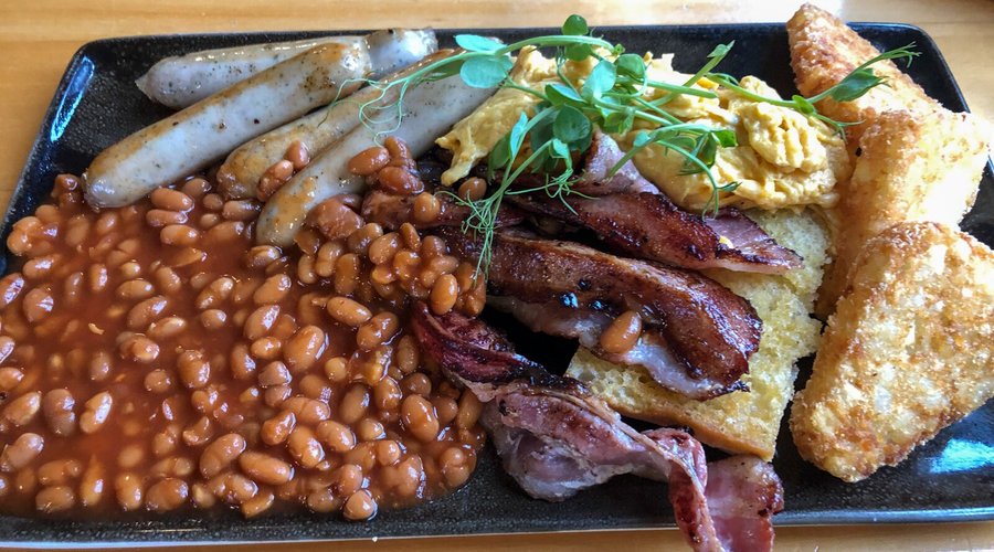 South Sea Hotel Good Morning Breakfast: Bacon, 2 eggs, ciabatta toast, hash browns, sausage, and baked beans.