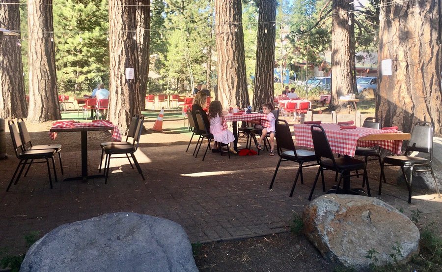 Our favorite COVID dining experience. Red-checkered tablecloths on tables in the trees!