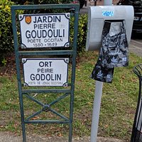 Sign for Jardin Pierre Goudouli near Stone plinth for Poet and story and teller Paul-Armand Silvestre.
