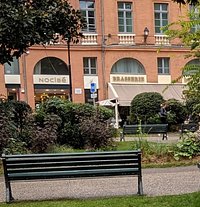 Shops in Place du President Thomas Wilson as seen from the Bust of Armand Silvestre.