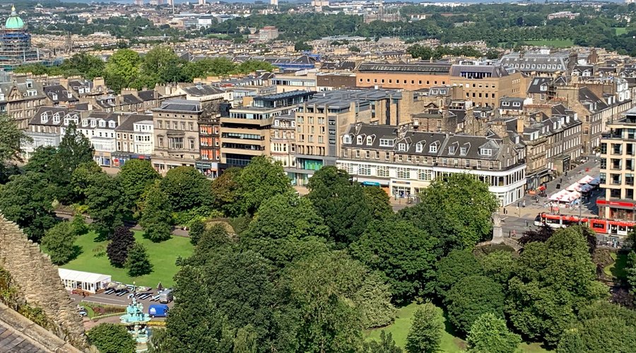 The view from the Castle battlements over Edinburgh with Princes Street Gardens and the Ross Fountain in the lower left