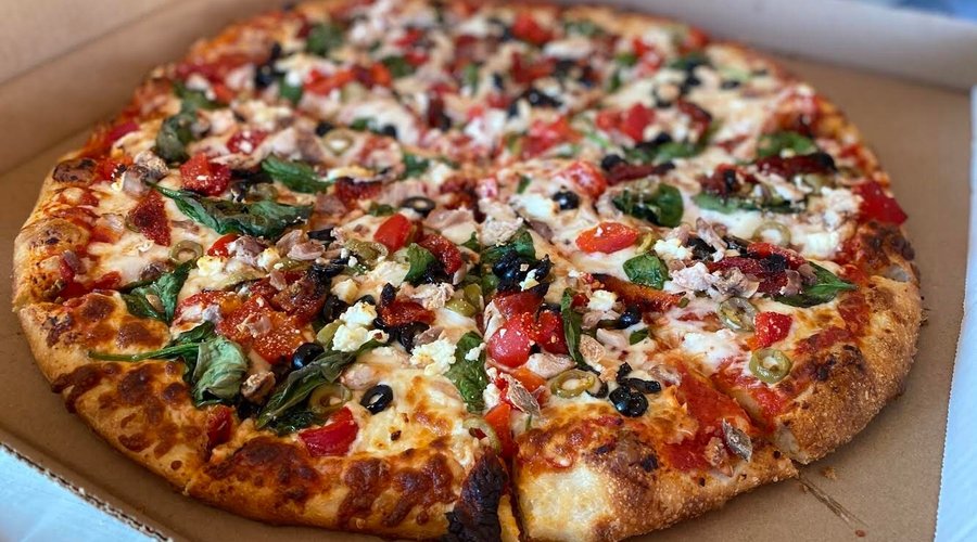 Every pizza is made with love. Nicky has created this delicious pizza with:
Spinach
Chicken
Goat Cheese
Roasted Red peppers
Sun Dried Tomatoes
Green & Black Olives!