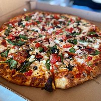 Every pizza is made with love. Nicky has created this delicious pizza with:
Spinach
Chicken
Goat Cheese
Roasted Red peppers
Sun Dried Tomatoes
Green & Black Olives!