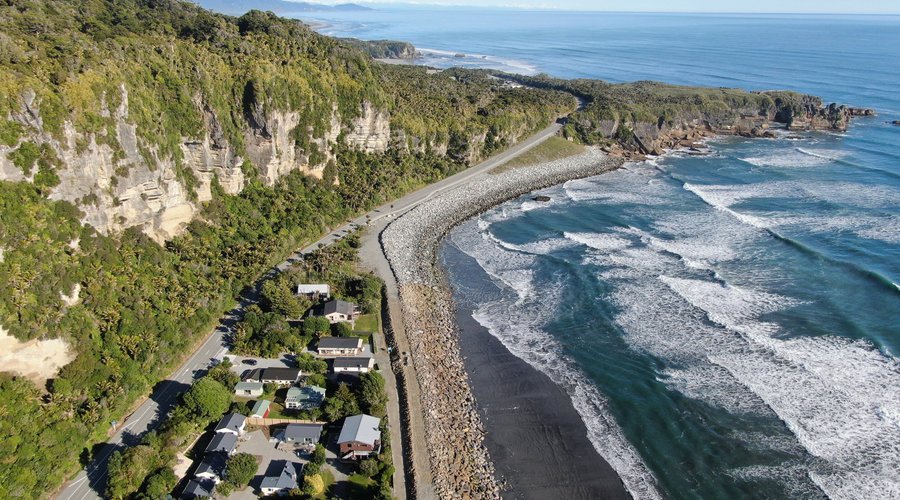 Drone view of the Motels, Tasman sea and Pancake Rocks in the distance