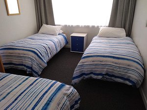 Kings Court Motel in Whanganui, image may contain: Furniture, Bedroom, Bed, Indoors